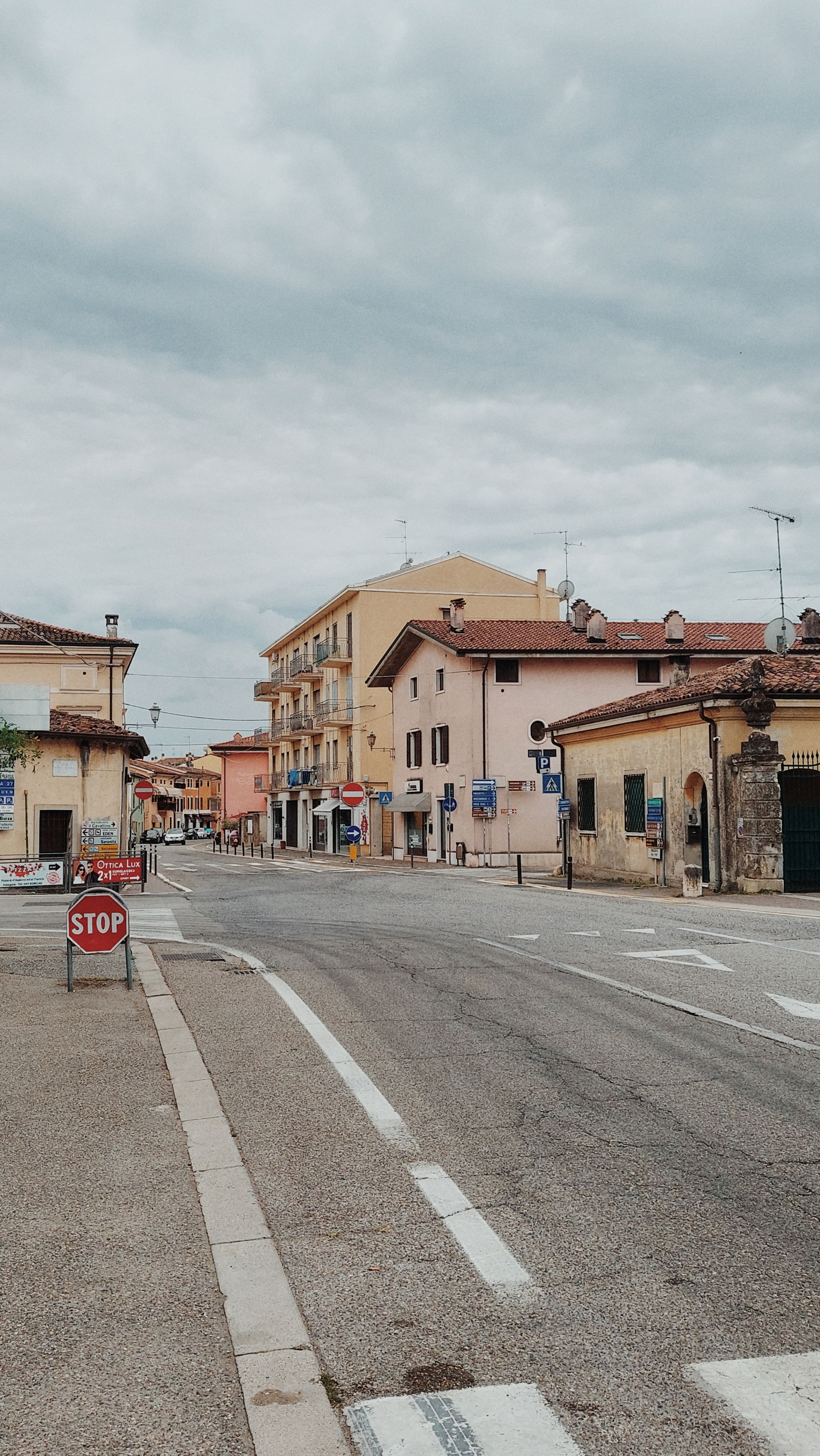 A southern small city. Crossroads, road, houses. No cars, no people. Troubled sky.