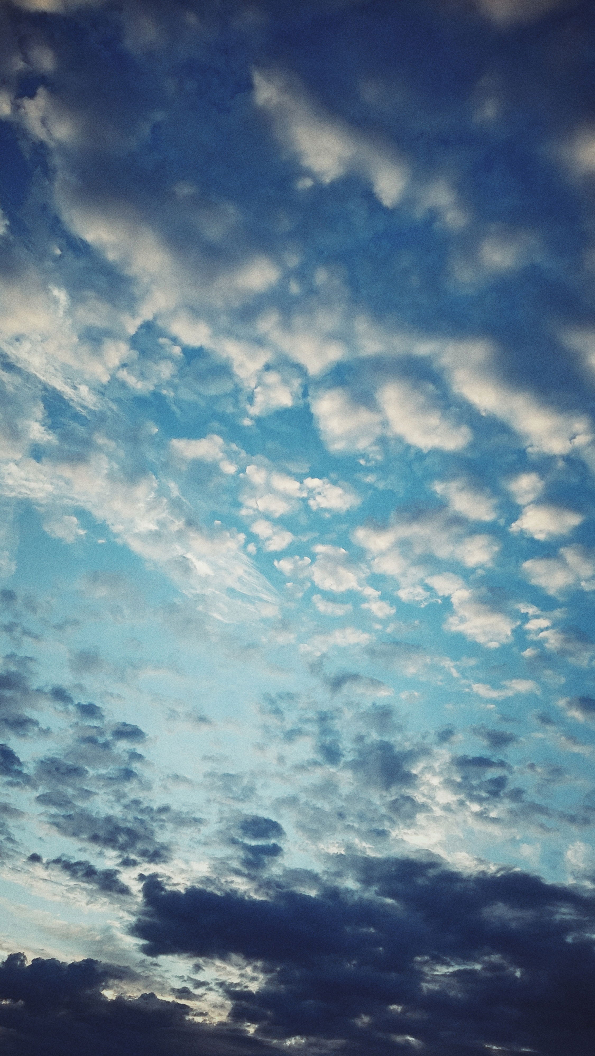 Morning clouds breaking up to a blue sky and sunrise. 
