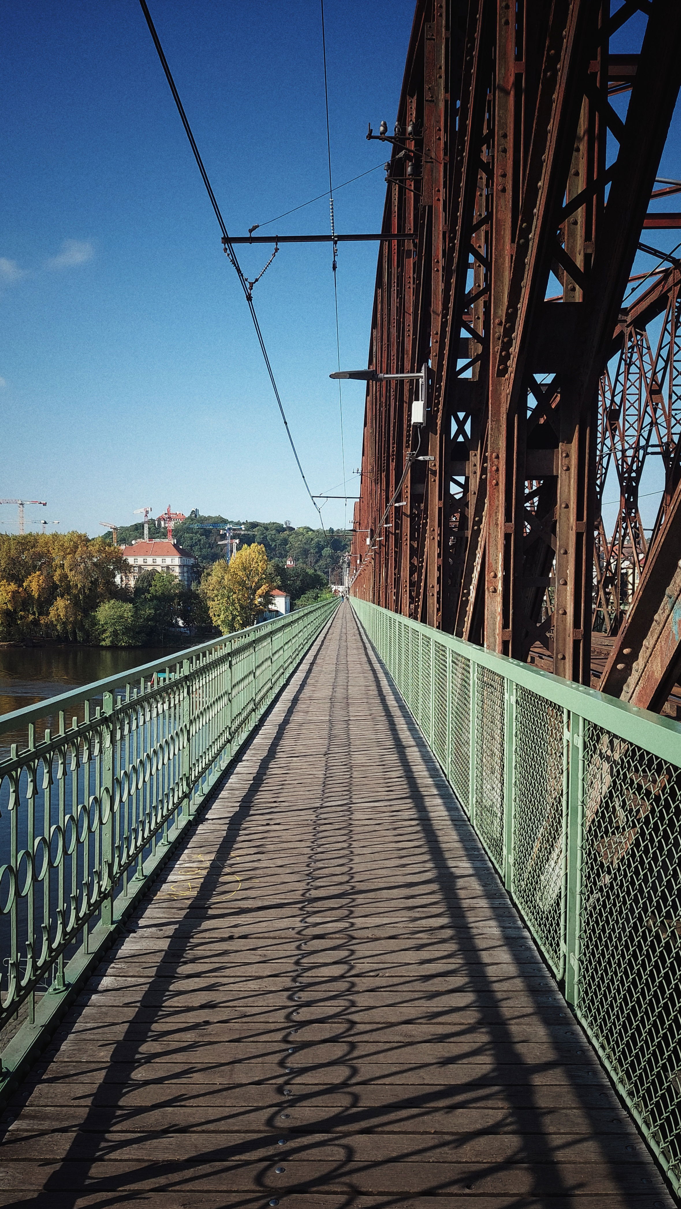 A walkway along a rusty iron bridge.