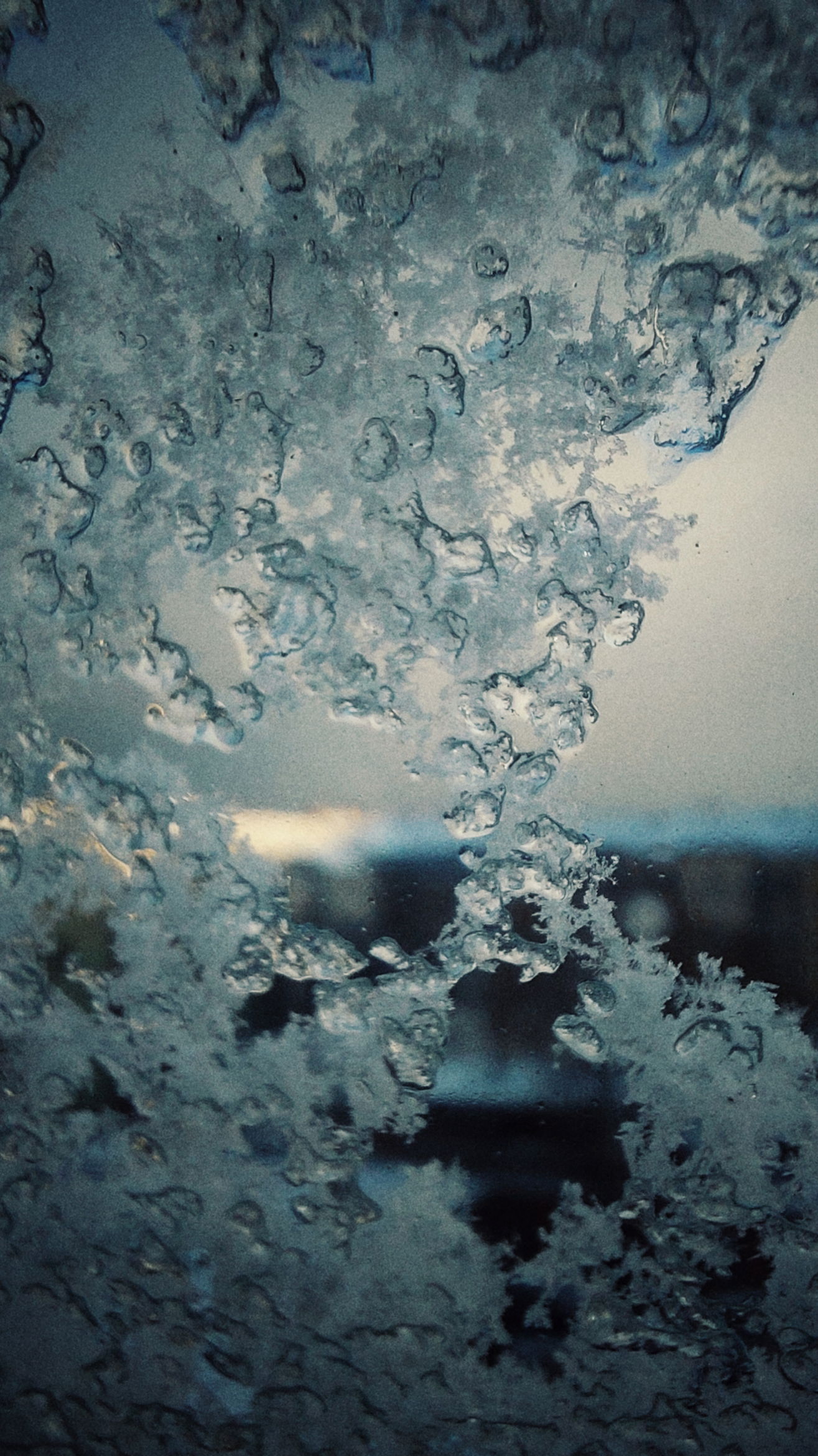 Fragments of snow and ice on a windowpane. 
