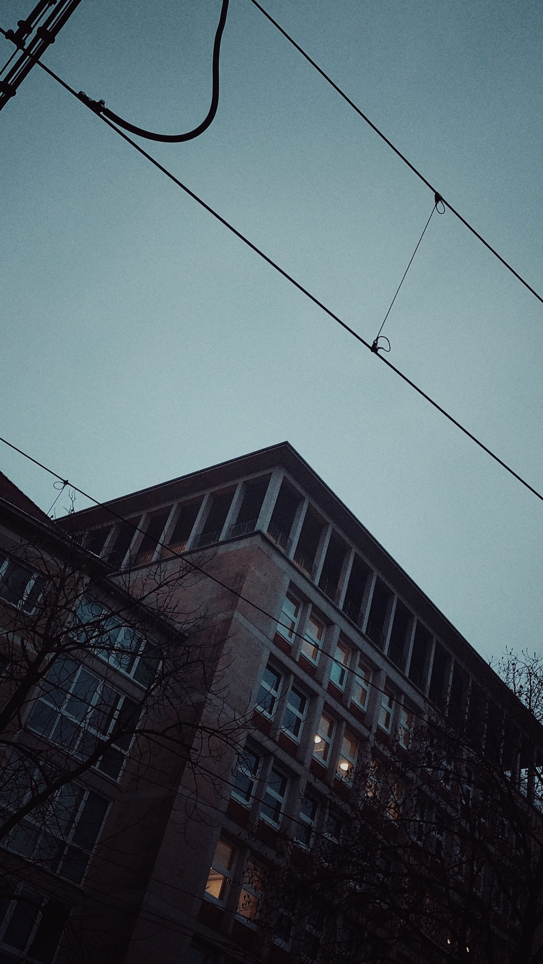 Facade of an office building. Some windows are lit.