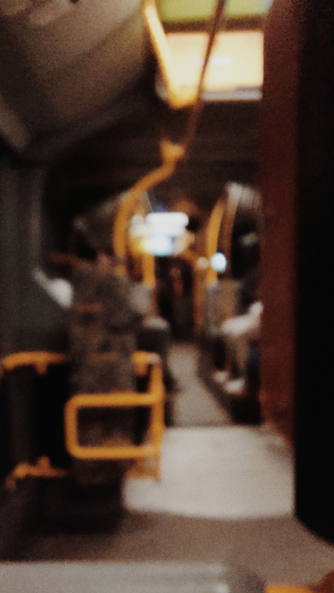 Blurred picture of a bus, mostly empty, early morning.