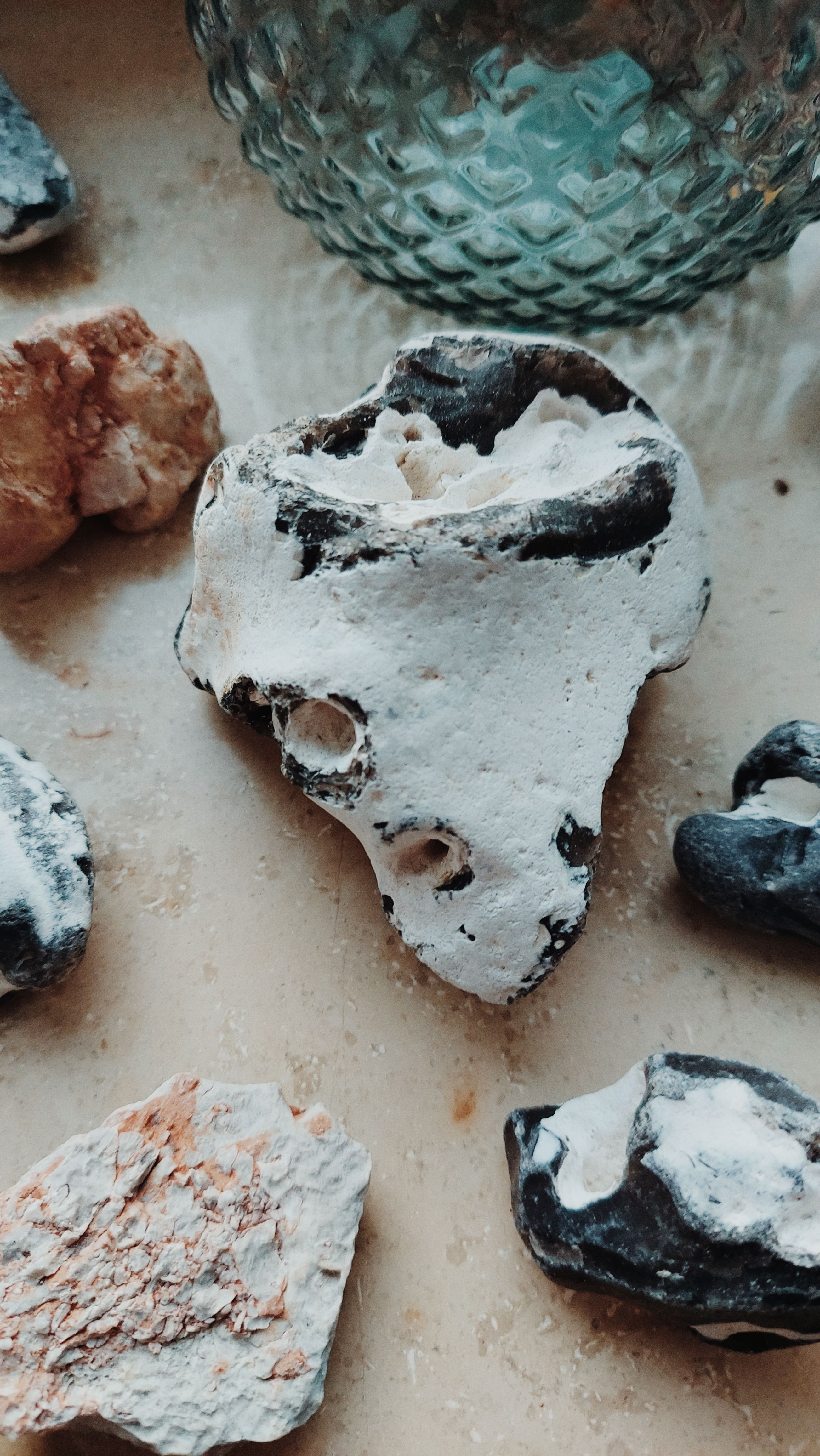 Island stones on a windowsill. A glass structure in the back.