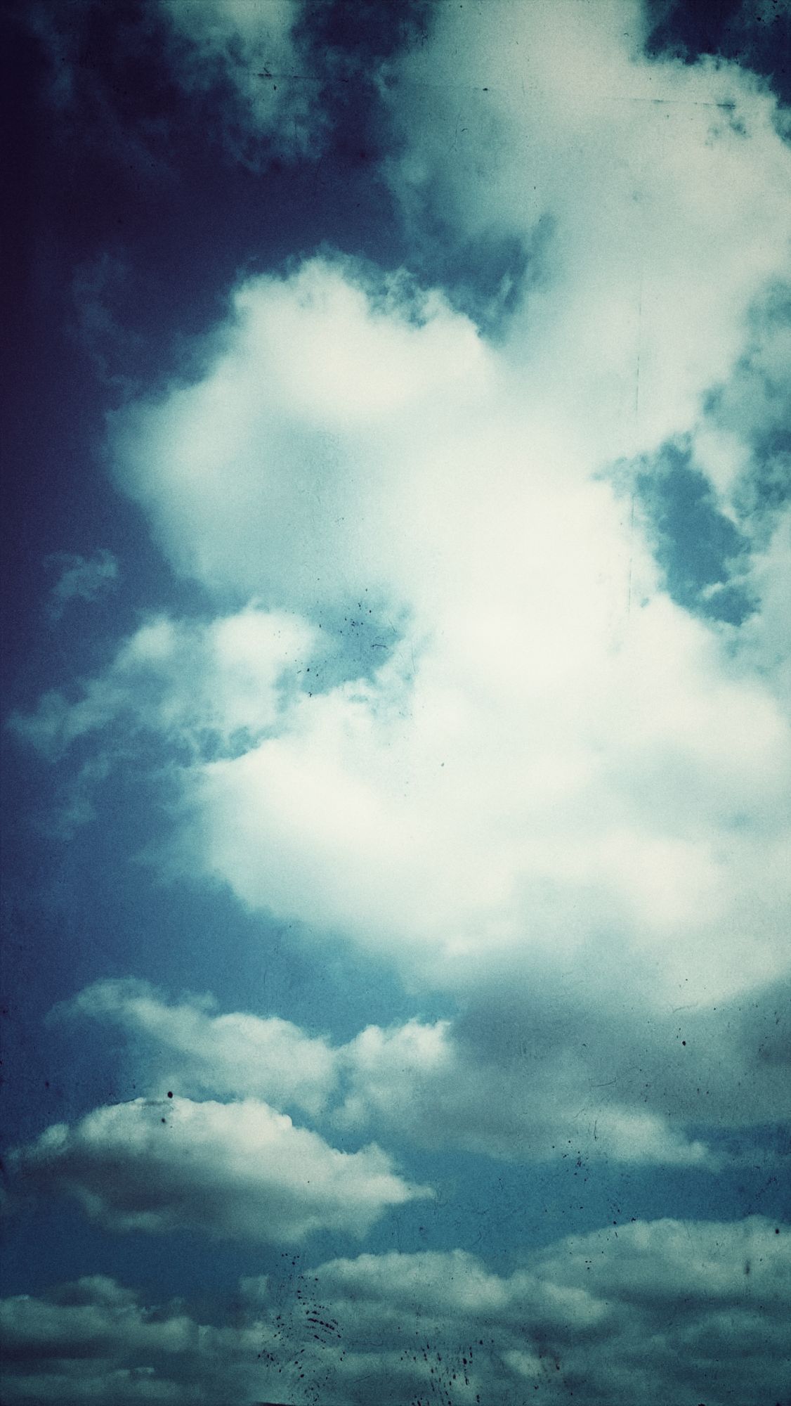 Blue sky, white clouds, retro-style image.