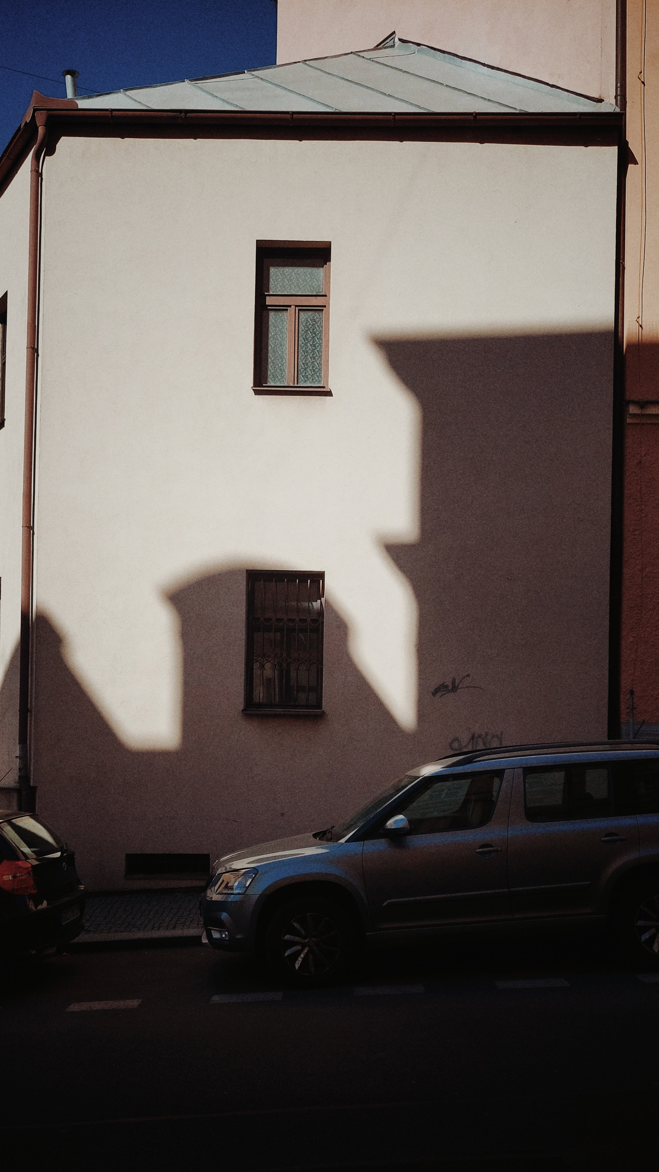 Strong shadow of a building on the wall of another. 