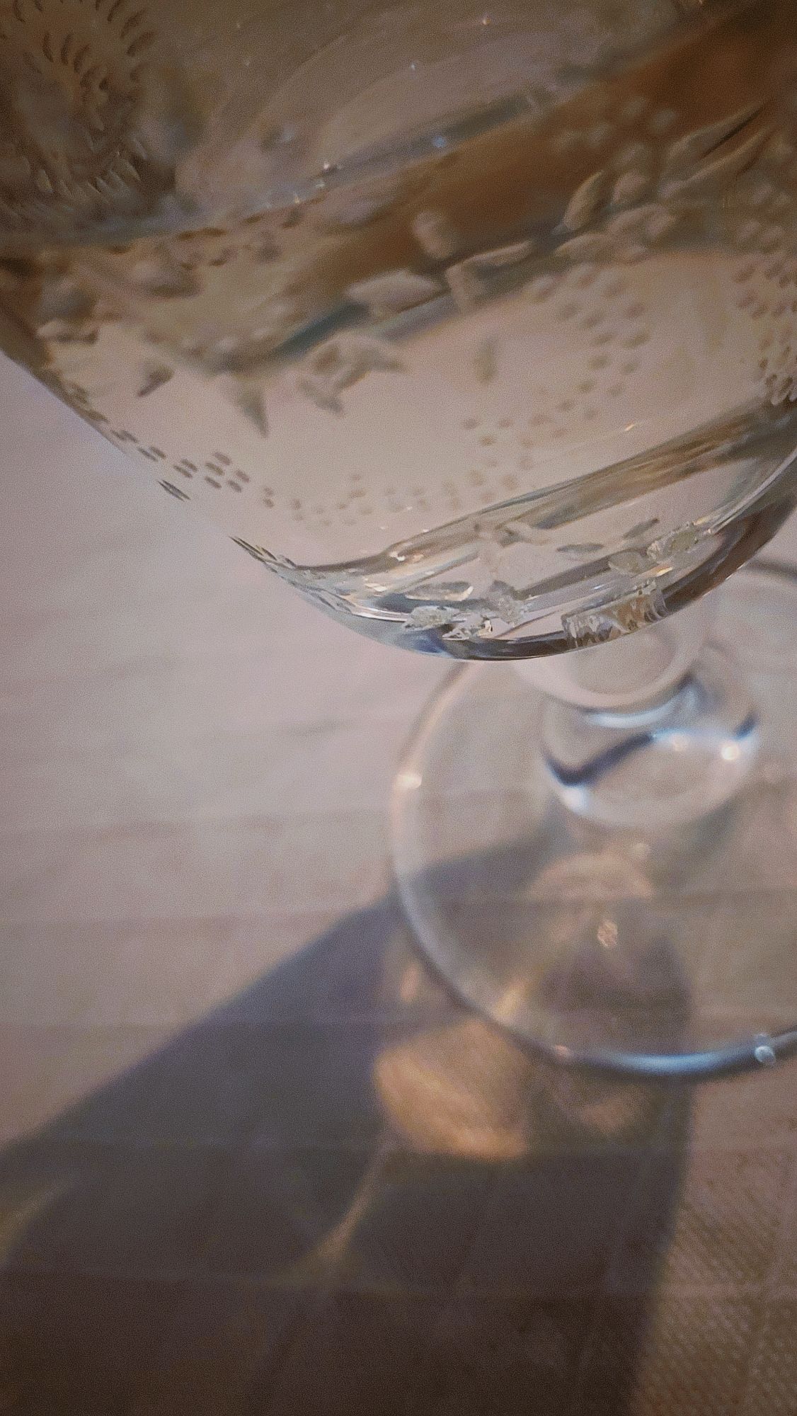 A different crystal glass containing white wine. 