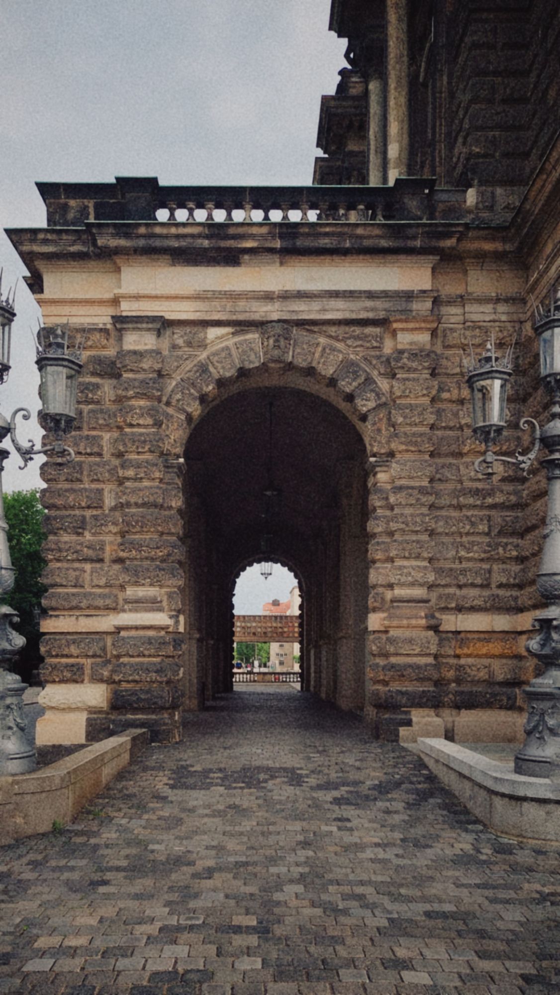 A portal in an old unique building. Lanterns left and right.