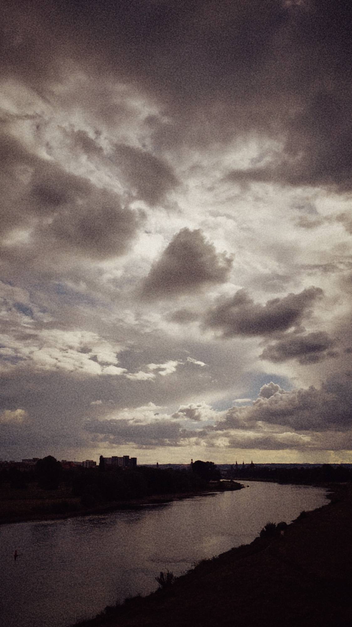 A river in late afternoon light. Clouds above.